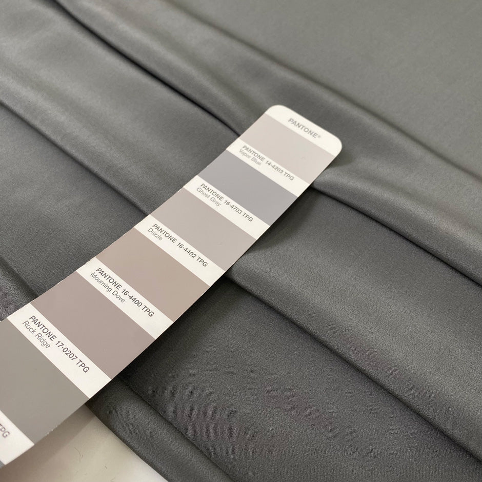 Pure silk crepe de chine in goth gray. Very soft and light, flowy, and not transparent. Ideal for shirting, blouses, dresses, and skirts. High-quality deadstock collected in Stock from a Maison de Couture in Italy.