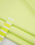 Textured fabric of pure bright green cotton. High-quality deadstock fabric collected in Stock from a Maison de Couture in Italy.