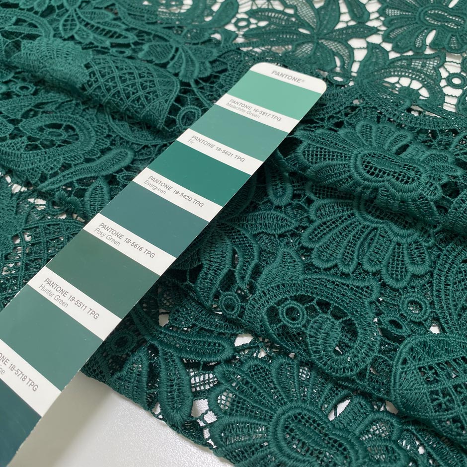 Light and soft polyester macro lace in dark green with a double scallop edge and baroque floral design. Perfect for dresses, skirts, and blouses.High-quality deadstock collected in Stock from a Maison de Couture in Italy.