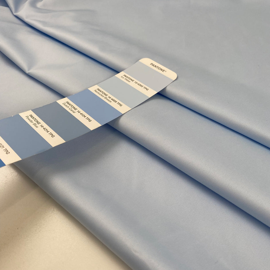 Light blue polyester fabric with a shiny effect, soft and slightly crunchy texture ideal for delicate details and overlays. High-quality deadstock collected in Stock from a Maison de Couture in Italy.