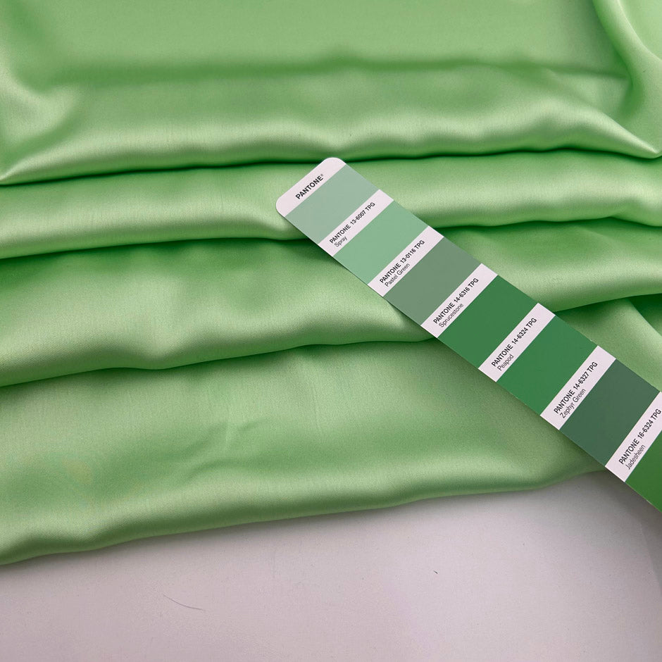 Light green polyester sateen with a soft, fluid drape and a non-stretch construction. Ideal for creating trousers and dresses. High-quality deadstock collected in Stock from a Maison de Couture in Italy.