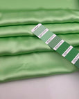 Light green polyester sateen with a soft, fluid drape and a non-stretch construction. Ideal for creating trousers and dresses. High-quality deadstock collected in Stock from a Maison de Couture in Italy.