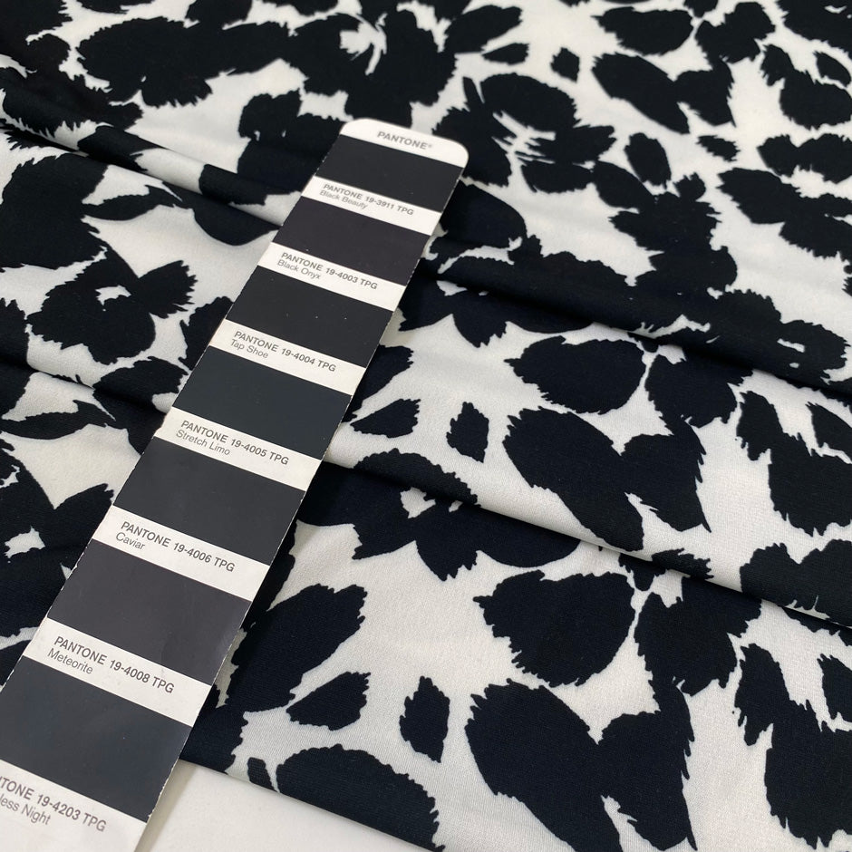 Printed polyester jersey with black spots on a white base soft and fluid ideal for tops dresses and layering pieces. High-quality deadstock collected in Stock from a Maison de Couture in Italy.