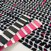 Pure viscose jersey with geometrical design in white, black, fuchsia, and green shades. Very soft, light, and stretchy. High-quality deadstock fabric collected in Stock from a Maison de Couture in Italy.