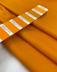 Heavy and soft cotton with elastane, in apricot orange. High-quality deadstock fabric collected in Stock from a Maison de Couture in Italy.