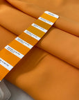 Medium-weight polyester cady in Iceland orange. Puffy, very soft and flowy, not transparent. Ideal for trousers, skirts, dresses, and heavy blouses. High-quality deadstock collected in Stock from a Maison de Couture in Italy.