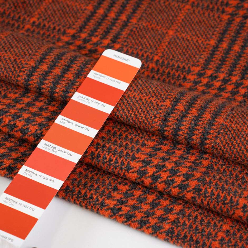 Prince of Wales knit of pure orange wool. The fabric is soft and strecthy. High quality deadstock fabric.