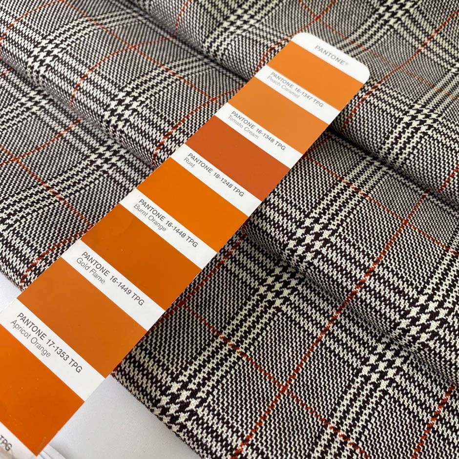 Pure virgin wool with a Prince of Wales check featuring a subtle red line. The pattern combines black, white, and orange tones for a bold yet timeless look. Ideal for jackets, skirts, and dresses. High-quality deadstock collected in Stock from a Maison de Couture in Italy.