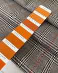 Pure virgin wool with a Prince of Wales check featuring a subtle red line. The pattern combines black, white, and orange tones for a bold yet timeless look. Ideal for jackets, skirts, and dresses. High-quality deadstock collected in Stock from a Maison de Couture in Italy.