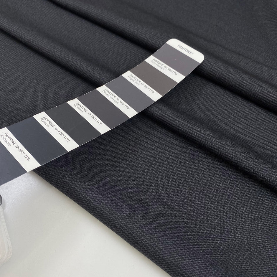 Double-face polyester and elastane fabric with dark grey front and light grey back, very soft and medium weight, ideal for reversible garments, jackets, and dresses. High-quality deadstock collected in Stock from a Maison de Couture in Italy. 