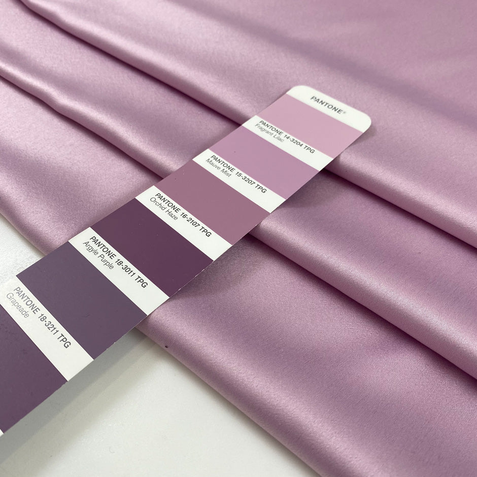 Lilac matte polyester satin with a soft hand and elegant drape, perfect for dresses, linings, and fluid pieces. High-quality deadstock collected in Stock from a Maison de Couture in Italy.
