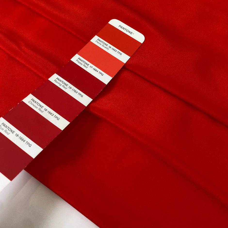 Crepe de chine in red color reference flame scarlet. Very soft and light, flowy and not transparent. Ideal for dresses, skirts, blouses, and shirting. High-quality deadstock collected in Stock from a Maison de Couture in Italy.
