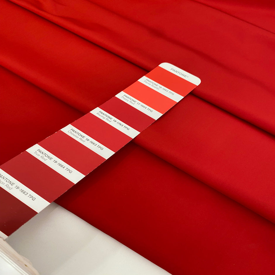 Silk and polyester taffeta in racing red. Light, crunchy, and structured. Keeps its shape.Ideal for skirts, dresses, and jackets. High-quality deadstock collected in Stock from a Maison de Couture in Italy.