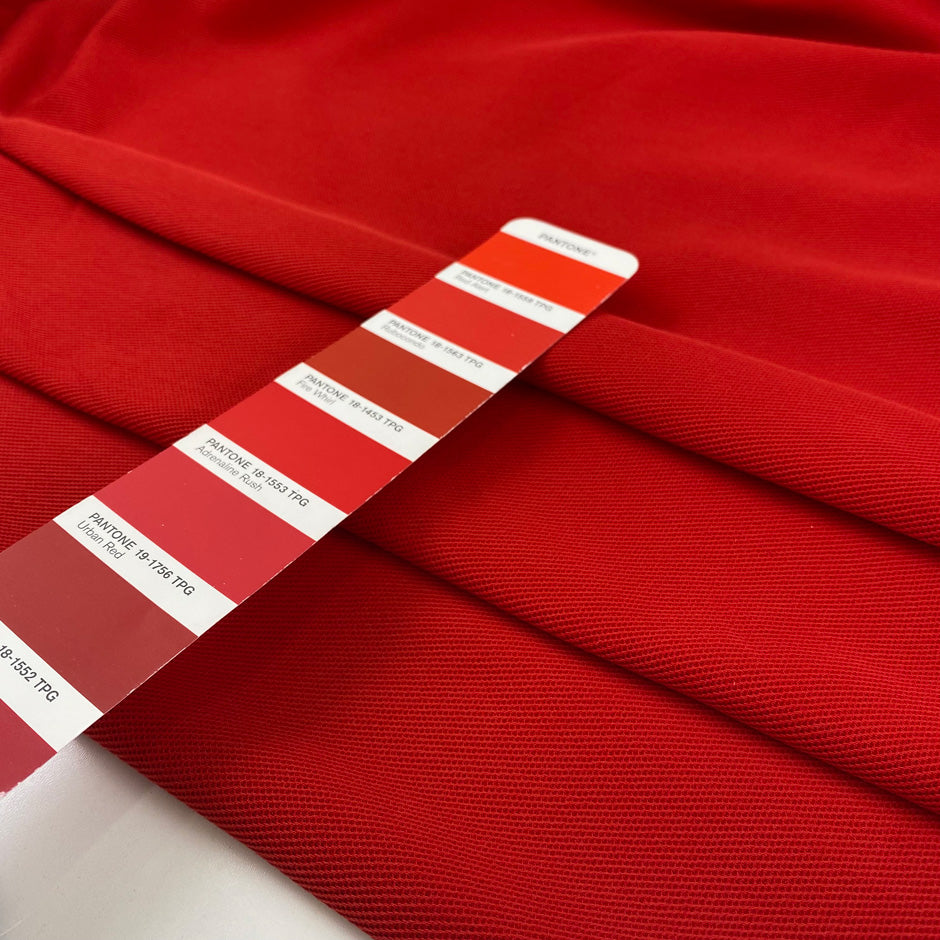Red heavy cotton jersey with a textured surface, slight stretch, and soft, flowy drape. High-quality deadstock collected in Stock from a Maison de Couture in Italy.