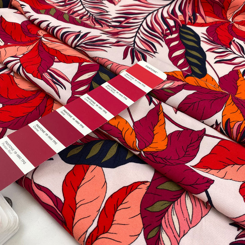 Printed viscose with tropical flower design in white, fuchsia, orange, and red shades. Very soft, light, and flowy. High-quality deadstock fabric by the meter collected in Stock from a Maison de Couture in Italy.