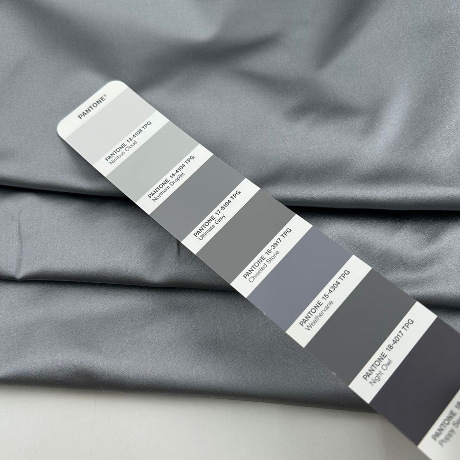 Silver pure silk duchesse satin, structured, lustrous and non-stretch. Perfect for skirts. High-quality deadstock collected in Stock from a Maison de Couture in Italy.