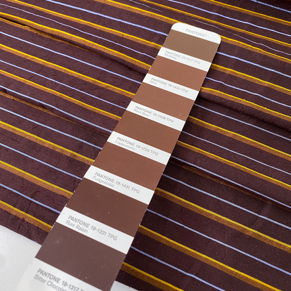 Pure silk shantung in dark brown with textured yellow and light blue stripes. Characteristic raw texture of shantung, ideal for dresses and skirts. High-quality deadstock collected in Stock from a Maison de Couture in Italy.