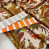 Printed soft polyester twill with small drawings. Orange, beige and bright green floral design. High-quality deadstock fabric collected in Stock from a Maison de Couture in Italy.