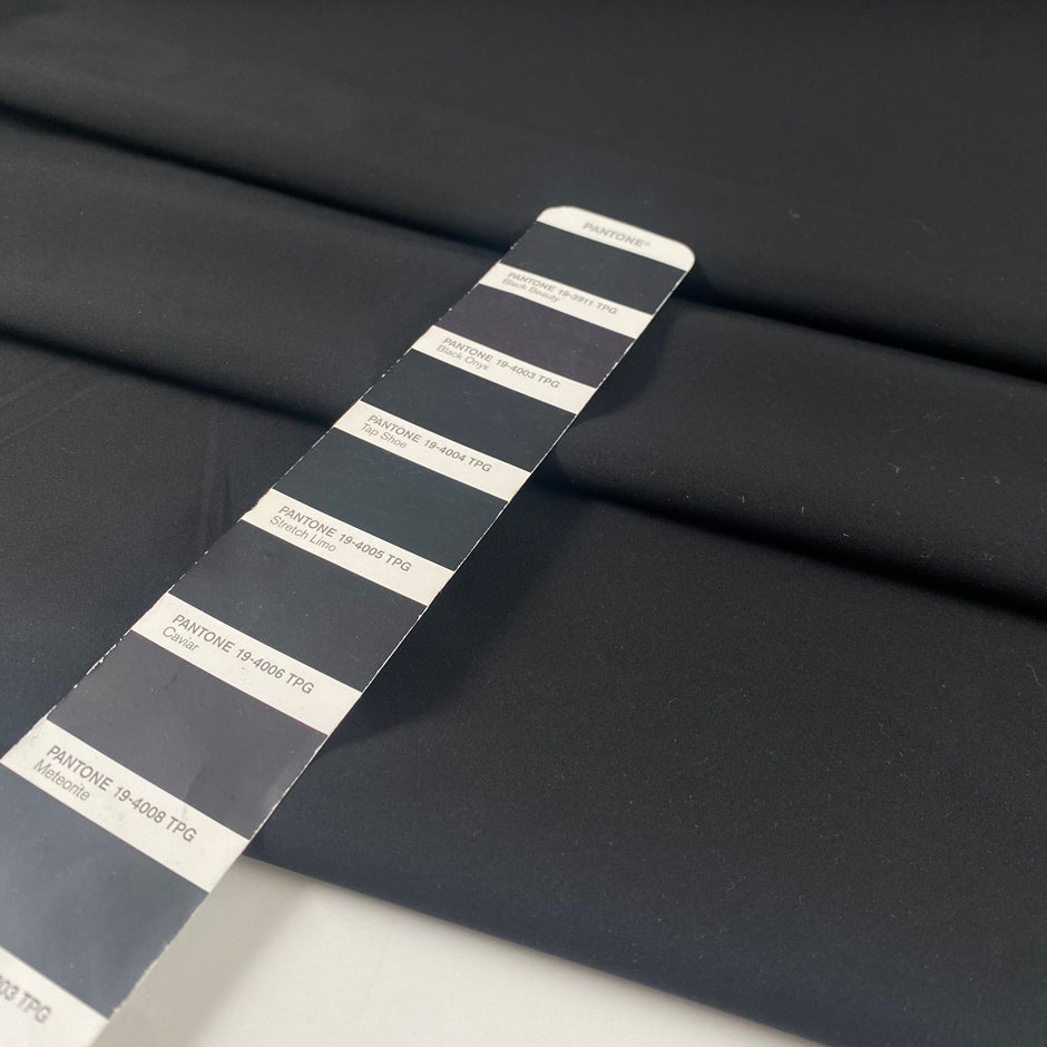 Black microfiber in polyester stretch, color reference tap shoe. A little bit crunchy and light, ideal for jackets, trenches, and trousers. High-quality deadstock collected in Stock from a Maison de Couture in Italy.