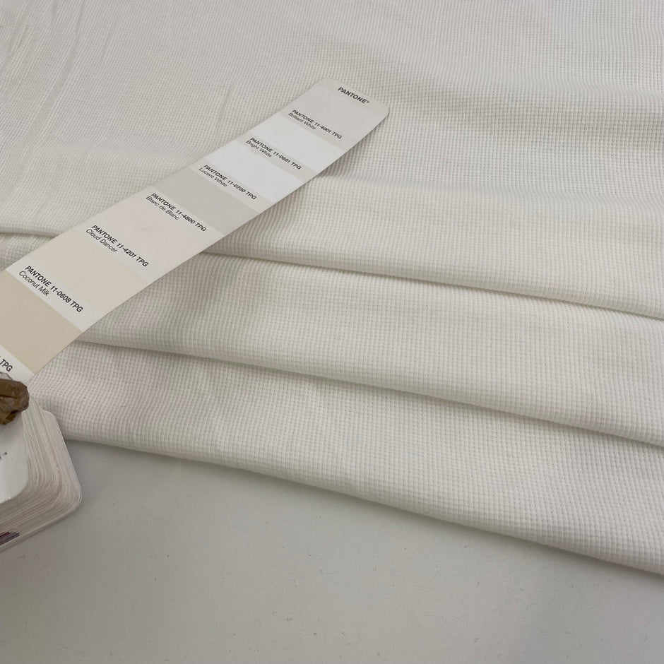 Pure white cotton jersey, stretchy and semi-trasparent. High quality deadstock fabric.