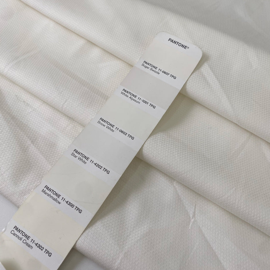 Stretch cotton piquet with texture in white color reference Sugar Swizzle. Very soft with low stretch. Ideal for trousers, dresses, skirts and jackets. High-quality deadstock collected in Stock from a Maison de Couture in Italy.