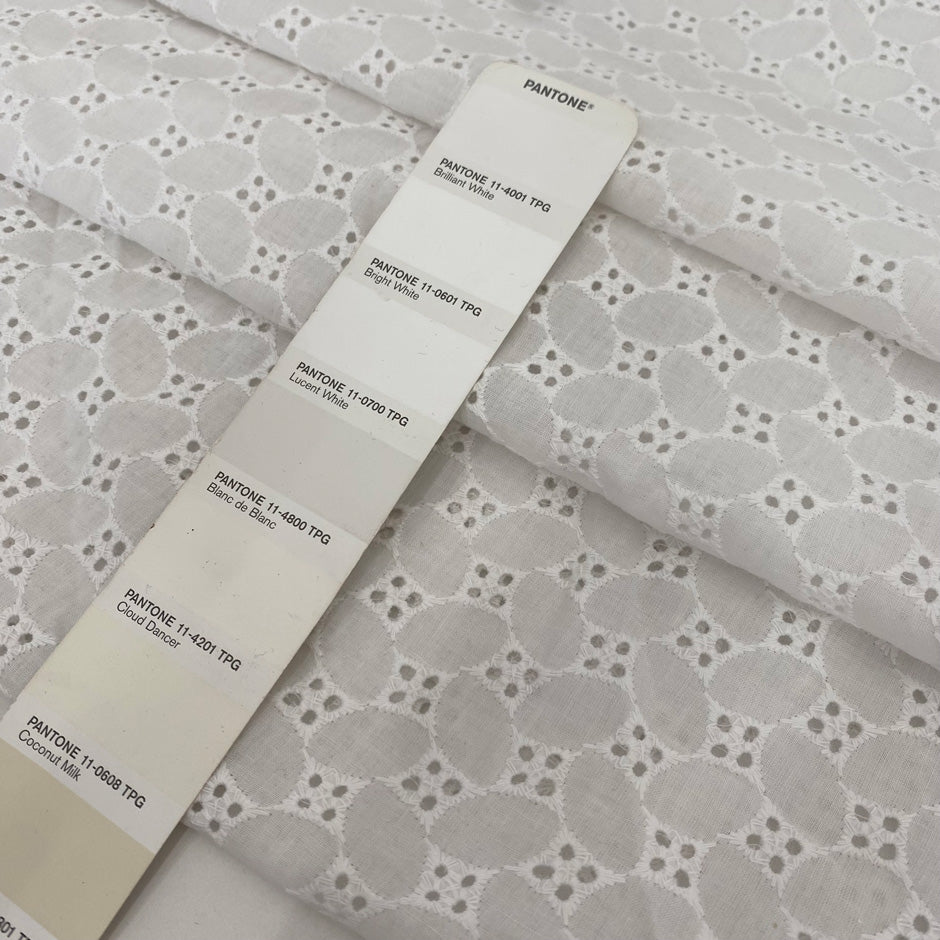 Pure cotton in bright white with geometric square embroidery. Very soft, light, and slightly transparent. Perfect for shirting, dresses, and skirts. High-quality deadstock collected in Stock from a Maison de Couture in Italy.
