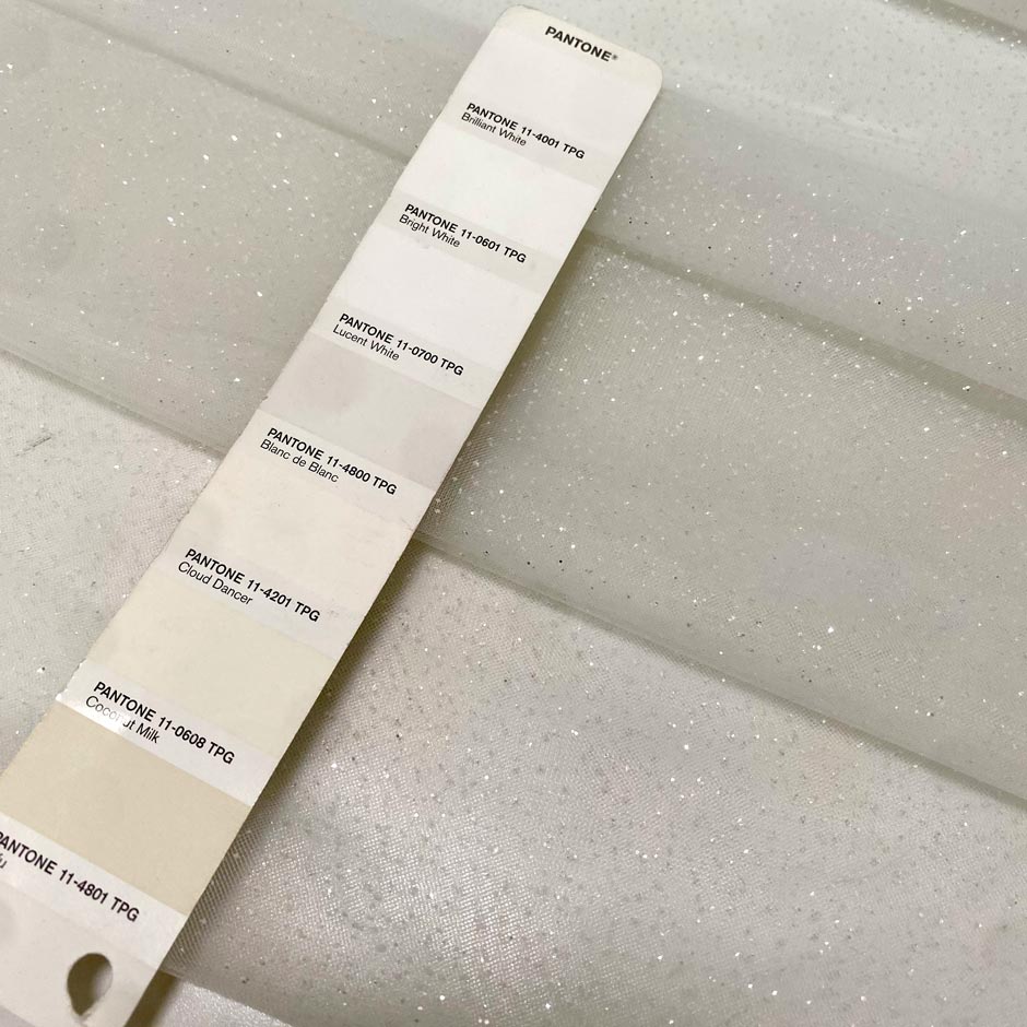 Soft polyester tulle in white with sparkling glitters. Light and delicate, perfect for dresses, skirts, blouses, and shirting.High-quality deadstock collected in Stock from a Maison de Couture in Italy.