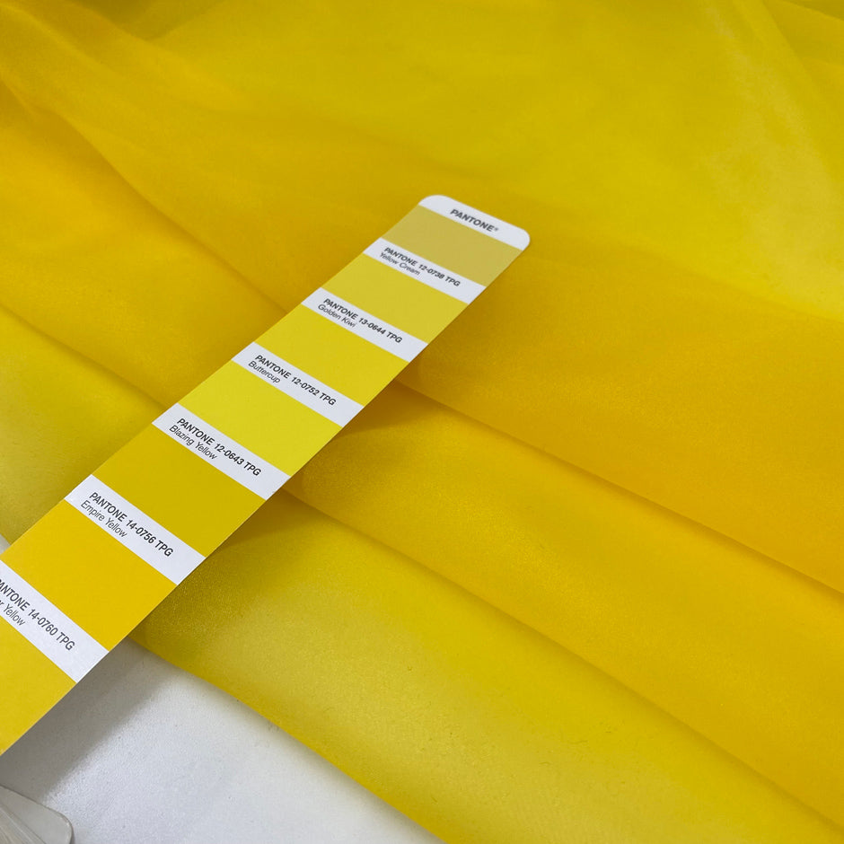 Bright yellow polyester organza transparent and light. High-quality deadstock fabric collected in Stock from a Maison de Couture in Italy.