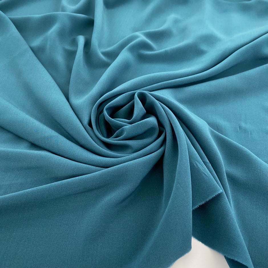 Silk crepe de chine, soft, droopy and transparent petrol green. High quality deadstock fabric.