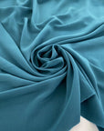 Silk crepe de chine, soft, droopy and transparent petrol green. High quality deadstock fabric.