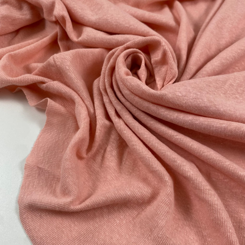 Stretch cotton and linen jersey in pink color reference English Rose. Very flowy and soft with a rough texture. Ideal for t-shirts, sweatshirts, dresses, skirts, and trousers. High-quality deadstock collected in Stock from a Maison de Couture in Italy.