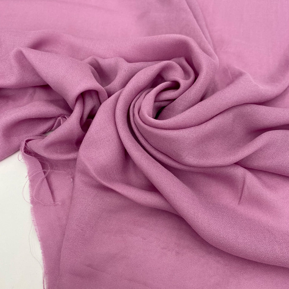 Soft and lightweight pure viscose muslin in pink, color reference Phalaenopsis. Flowy and breathable, ideal for light shirting, dresses, and skirts.High-quality deadstock collected in Stock from a Maison de Couture in Italy.