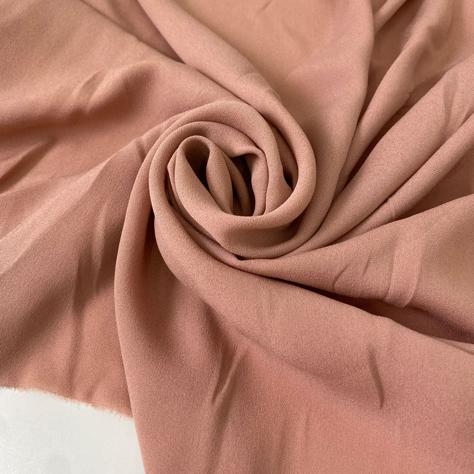 Soft and lightweight pink pure silk georgette. Faintly textured, flowy, and not transparent. Ideal for dresses, skirts, blouses, and shirting.High-quality deadstock collected in Stock from a Maison de Couture in Italy.