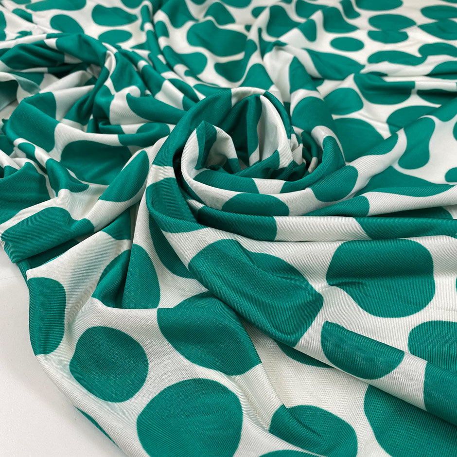 Pure viscose jersey with big green Pois dots on a white background. very soft, stretch, and light. High-quality deadstock fabric collected in Stock from a Maison de Couture in Italy.