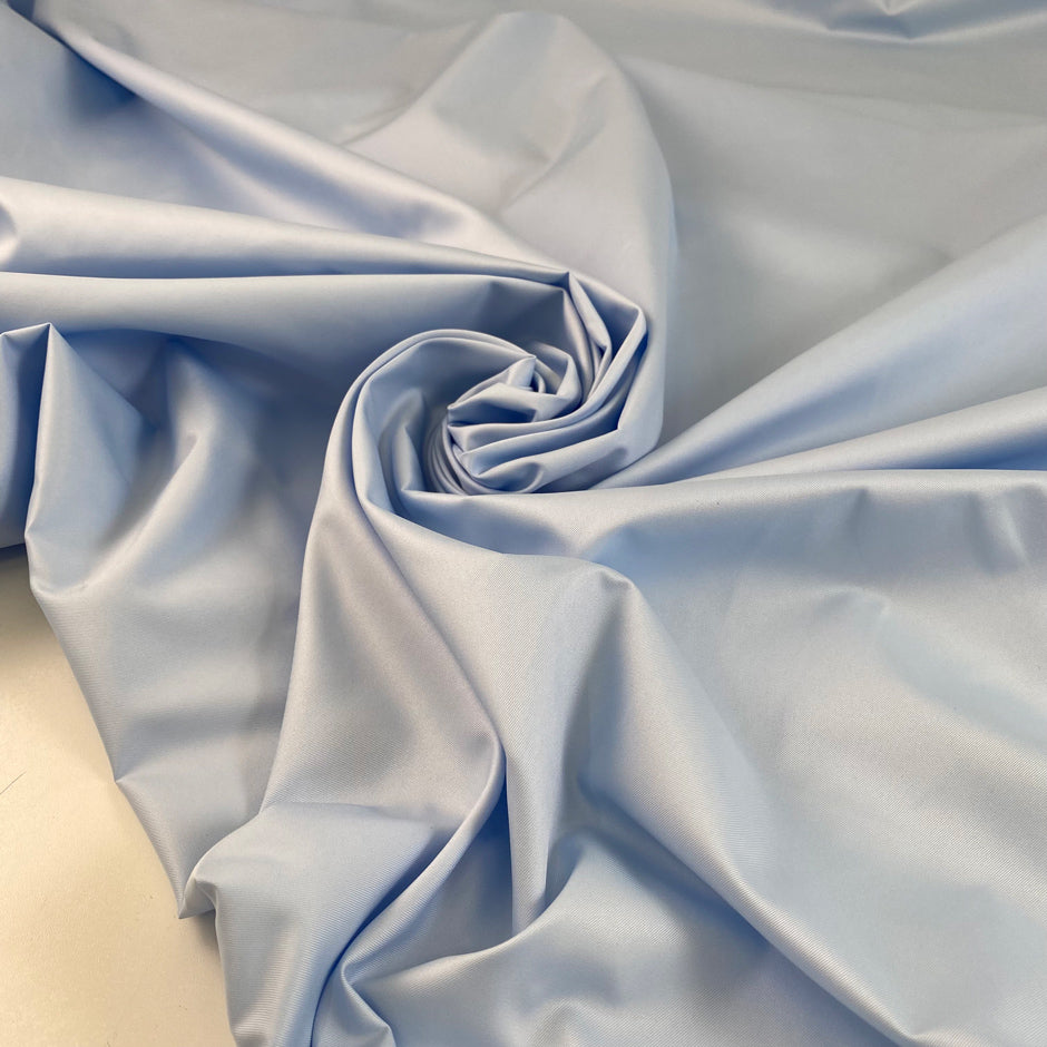 Light blue polyester fabric with a shiny effect, soft and slightly crunchy texture ideal for delicate details and overlays. High-quality deadstock collected in Stock from a Maison de Couture in Italy.
