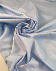 Light blue polyester fabric with a shiny effect, soft and slightly crunchy texture ideal for delicate details and overlays. High-quality deadstock collected in Stock from a Maison de Couture in Italy.