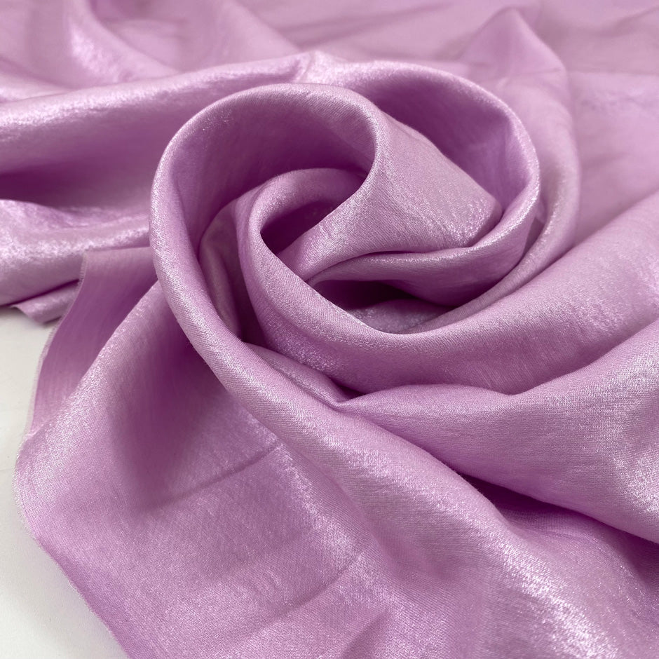 Viscose and polyester light cady, very shiny in orchid violet. Very soft and flowy. High-quality deadstock fabric by the meter collected in Stock from a Maison de Couture in Italy.