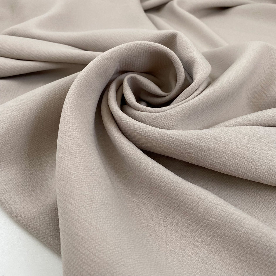 Polyester and elastane cady with textured in white sand, very soft, flowy, and not transparent. High-quality deadstock fabric collected in Stock from a Maison de Couture in Italy.