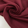 Wool and polyester tweed is heavy in bordeaux and textured. High-quality deadstock fabric by the meter collected in Stock from a Maison de Couture in Italy.