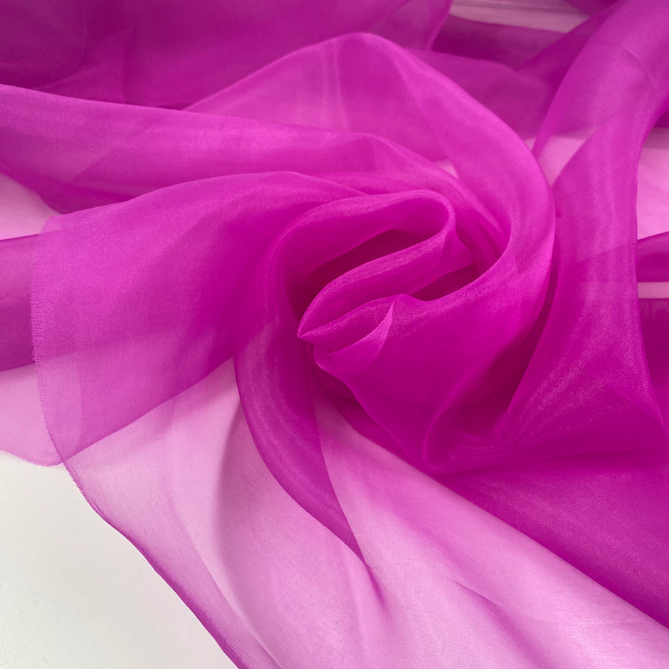 Polyester organza very light and transparent a litlle shiny in bright fuchsia. High-quality deadstock fabric collected in Stock from a Maison de Couture in Italy.