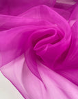 Polyester organza very light and transparent a litlle shiny in bright fuchsia. High-quality deadstock fabric collected in Stock from a Maison de Couture in Italy.