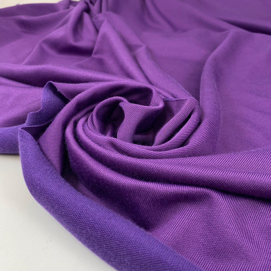 Polyester jersey in violet, very soft, light, and slightly shiny, ideal for dresses, tops, and layering pieces. High-quality deadstock collected in Stock from a Maison de Couture in Italy.