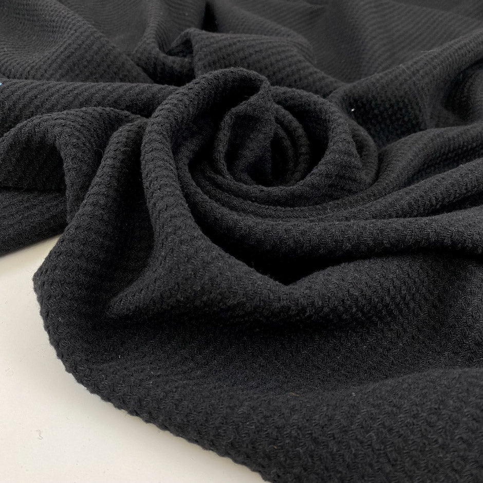 Black mesh fabric in a blend of cotton, polyester, and elastane with a textured surface, soft, breathable, and slightly stretchy. Ideal for inserts, layering, and sporty pieces. High-quality deadstock collected in Stock from a Maison de Couture in Italy.