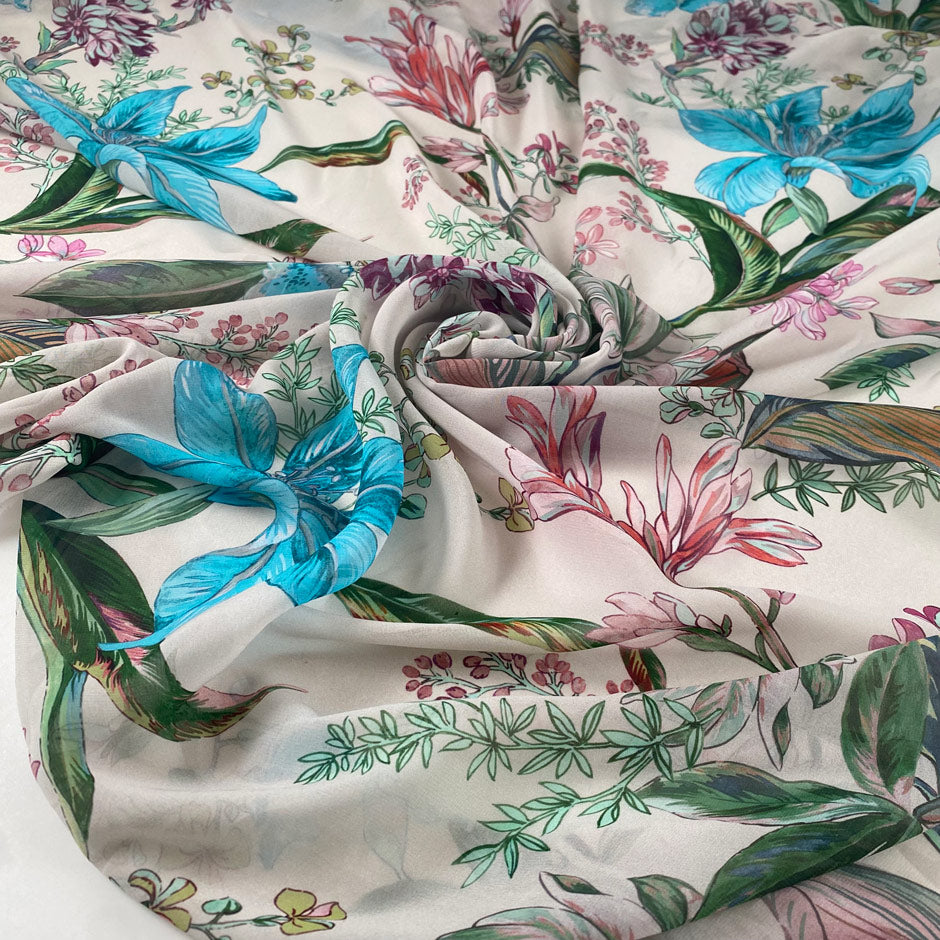 Polyester chiffon printed with floral and leaf design in shades of pink, green, and light blue. Very light, flowy, and transparent. High-quality deadstock collected in Stock from a Maison de Couture in Italy.