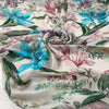 Polyester chiffon printed with floral and leaf design in shades of pink, green, and light blue. Very light, flowy, and transparent. High-quality deadstock collected in Stock from a Maison de Couture in Italy.