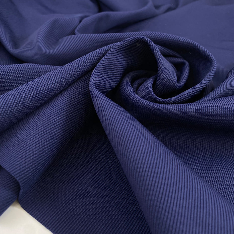 Stretch polyester jersey in blue with textured very soft and heavy. High-quality deadstock fabric collected in Stock from a Maison de Couture in Italy.