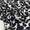 Printed polyester jersey with black spots on a white base soft and fluid ideal for tops dresses and layering pieces. High-quality deadstock collected in Stock from a Maison de Couture in Italy.