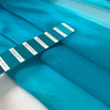 Polyester organza very shiny light and transparent, in bright turquoise. High-quality deadstock fabric collected in Stock from a Maison de Couture in Italy.