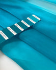 Polyester organza very shiny light and transparent, in bright turquoise. High-quality deadstock fabric collected in Stock from a Maison de Couture in Italy.