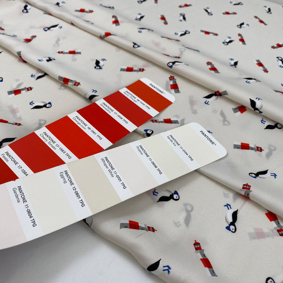 Very soft and light polyester satin with ivory ground and small fantasy design of birds and lighthouses. Not transparent. High-quality deadstock collected in Stock from a Maison de Couture in Italy.